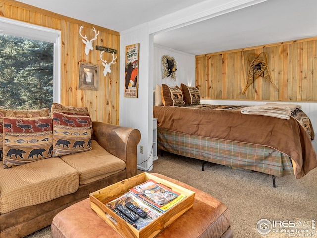 carpeted bedroom featuring crown molding and wooden walls