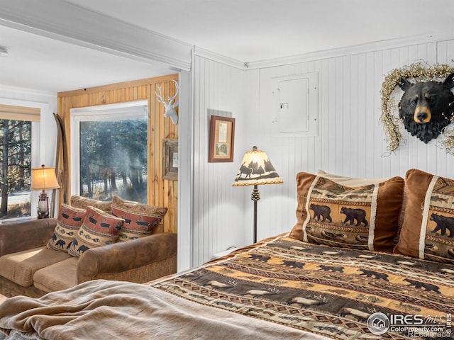 bedroom featuring electric panel, crown molding, and wood walls