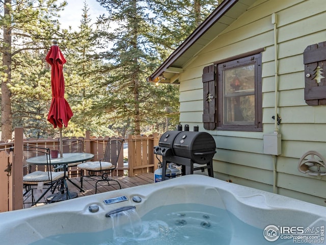 deck featuring area for grilling and a hot tub