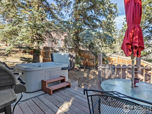 wooden deck featuring a hot tub