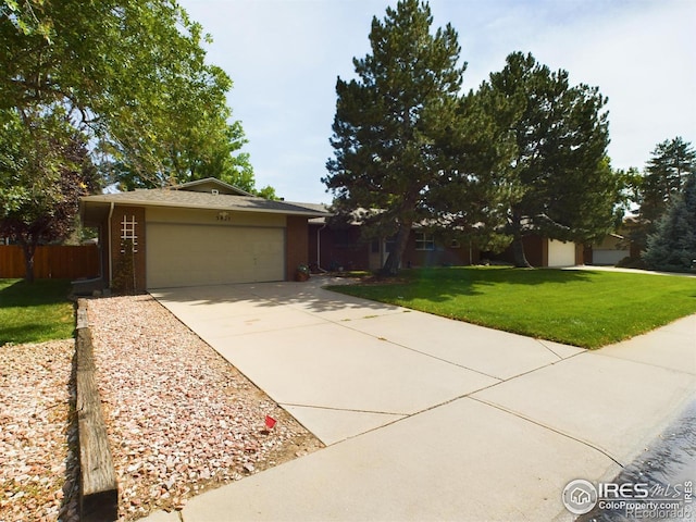 view of front of home with a front lawn and a garage