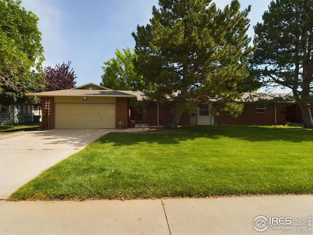 ranch-style home with a garage and a front lawn