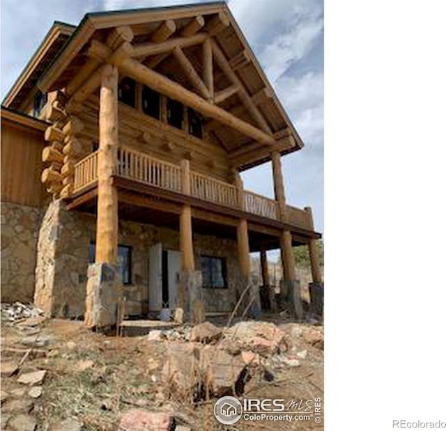 387 Lakeview Dr, Drake, CO 80515 - view of front of house featuring log exterior, stone siding, and a wooden deck