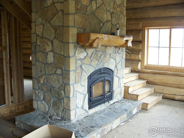 387 Lakeview Dr, Drake, CO 80515 - detailed view of log walls, heating unit, and a fireplace