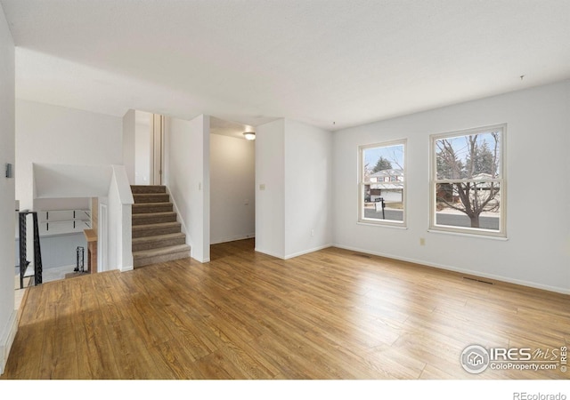 unfurnished living room featuring light hardwood / wood-style flooring