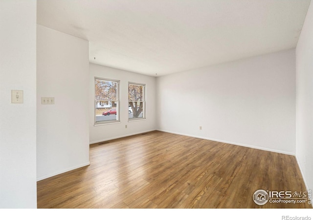 unfurnished room featuring hardwood / wood-style flooring