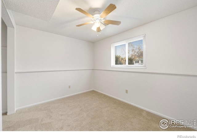 unfurnished room with ceiling fan and light carpet