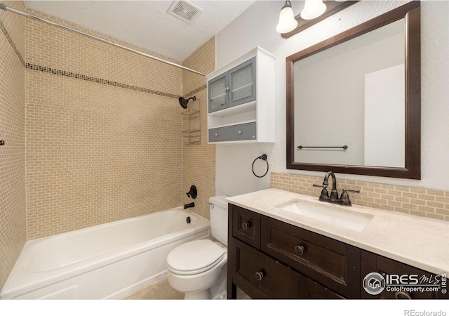 full bathroom with backsplash, toilet, vanity, and tiled shower / bath