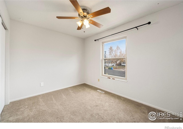 unfurnished room featuring carpet floors and ceiling fan