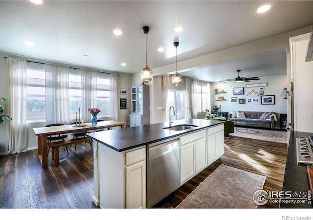 kitchen featuring pendant lighting, dishwasher, a healthy amount of sunlight, and white cabinetry