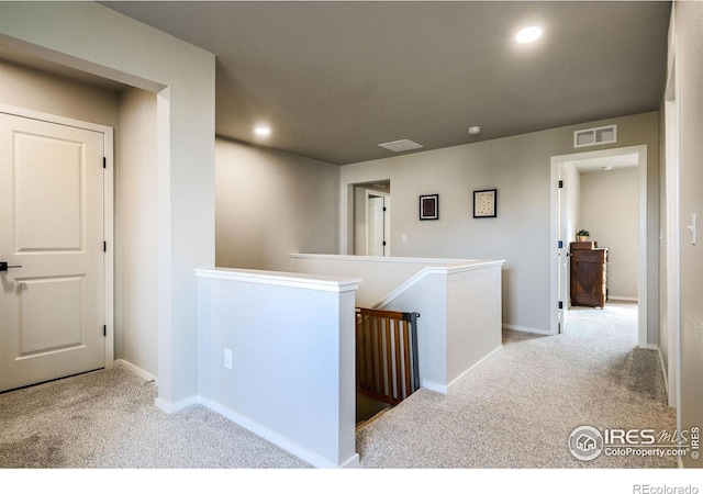 corridor with light colored carpet