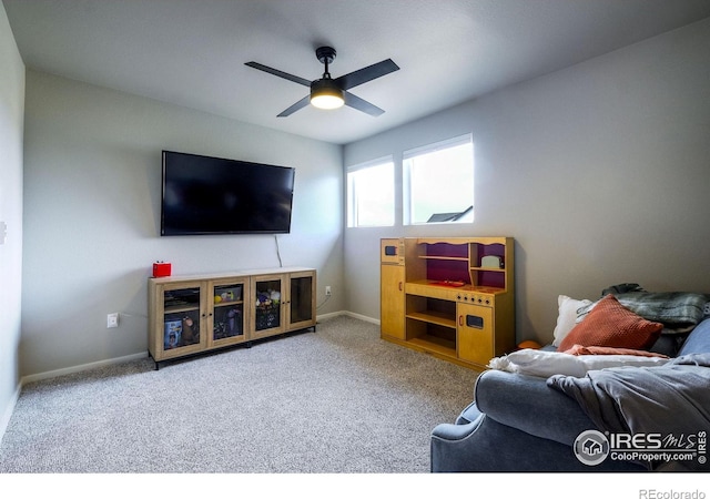 carpeted living room with ceiling fan