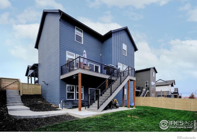 rear view of house featuring a yard and a patio