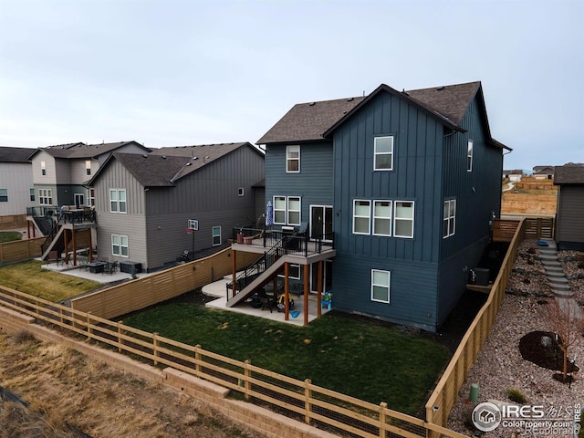 rear view of property with a patio area, a yard, and a deck