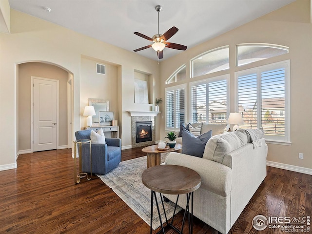 living room featuring ceiling fan and dark hardwood / wood-style floors