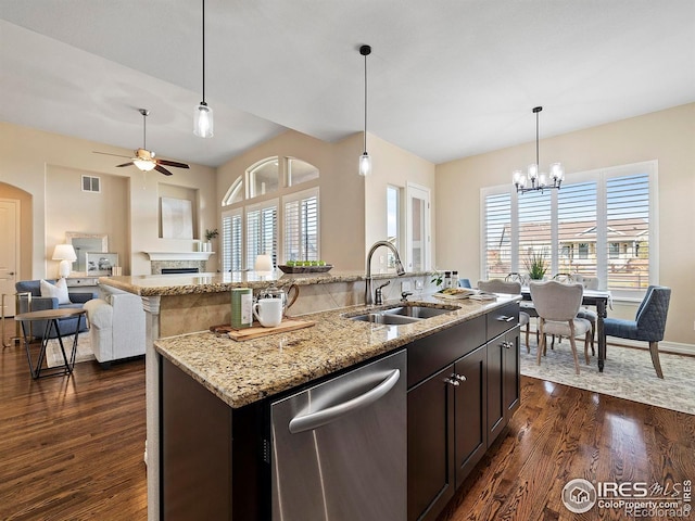 kitchen with dark hardwood / wood-style floors, stainless steel dishwasher, plenty of natural light, and sink