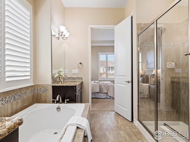 bathroom featuring tile patterned floors, vanity, and separate shower and tub