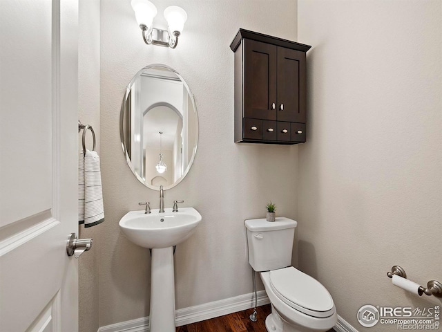 bathroom with hardwood / wood-style floors and toilet