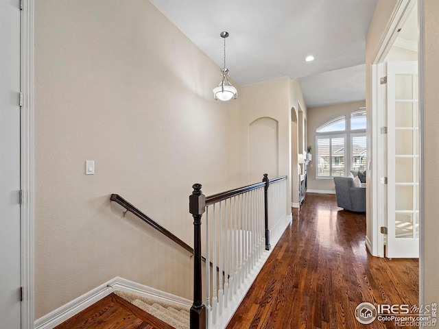 corridor featuring vaulted ceiling and dark hardwood / wood-style floors