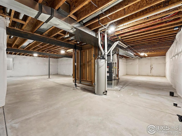 basement featuring gas water heater and heating unit