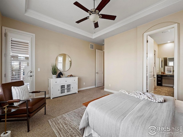 bedroom with ornamental molding, a tray ceiling, ceiling fan, and light colored carpet