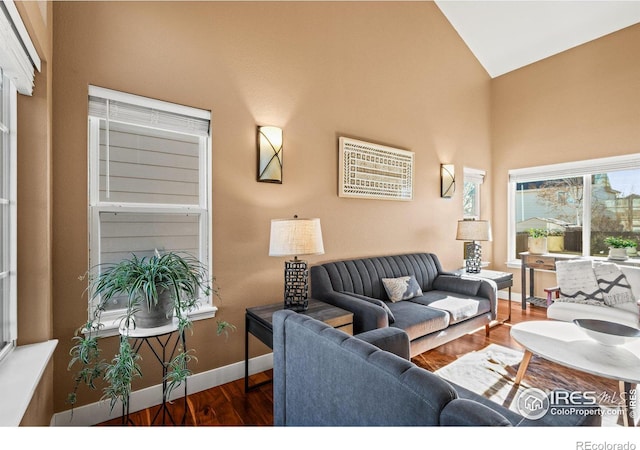 living room with dark hardwood / wood-style flooring and lofted ceiling