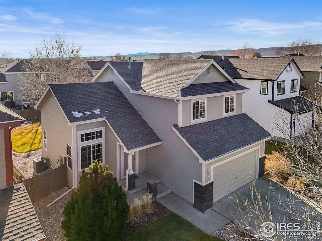 view of front of home featuring central AC and a garage