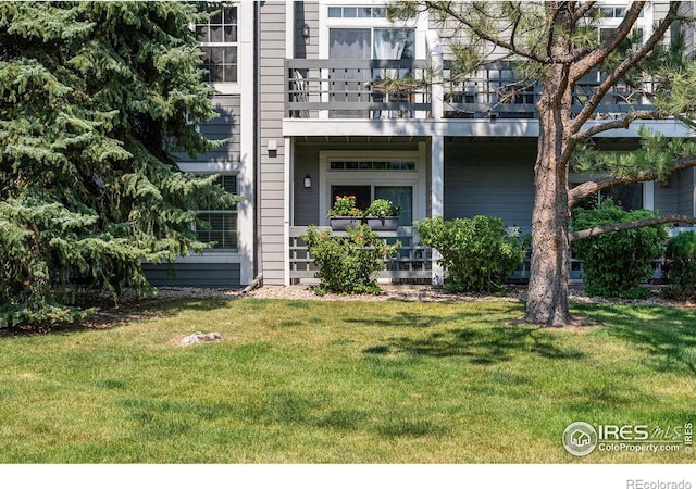 entrance to property with a lawn