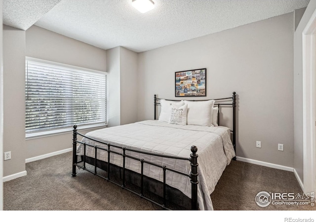 carpeted bedroom with a textured ceiling