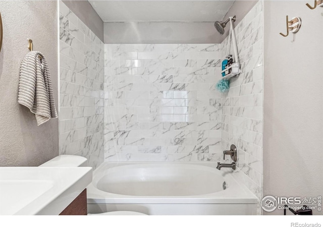 bathroom featuring vanity and tiled shower / bath