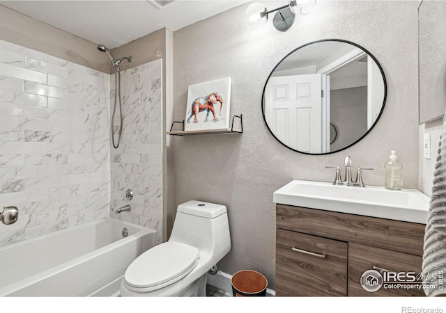 full bathroom featuring tiled shower / bath combo, toilet, and vanity