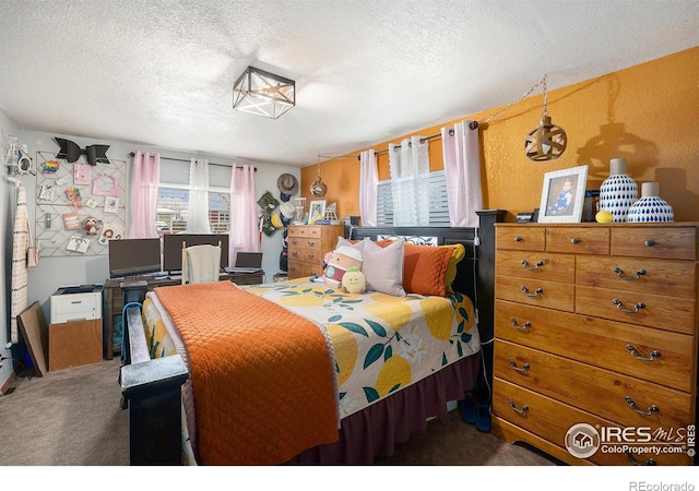 bedroom with carpet and a textured ceiling