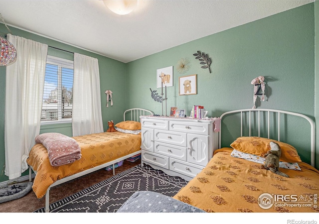 carpeted bedroom with a textured ceiling