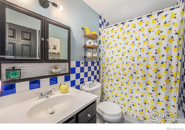 bathroom featuring tasteful backsplash, toilet, vanity, tile walls, and a shower with shower curtain