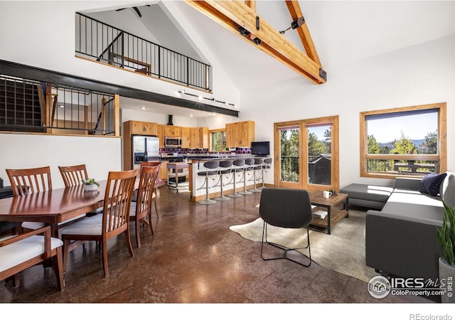 living room with beamed ceiling and high vaulted ceiling