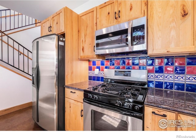 kitchen featuring decorative backsplash, light brown cabinets, stainless steel appliances, and dark stone counters