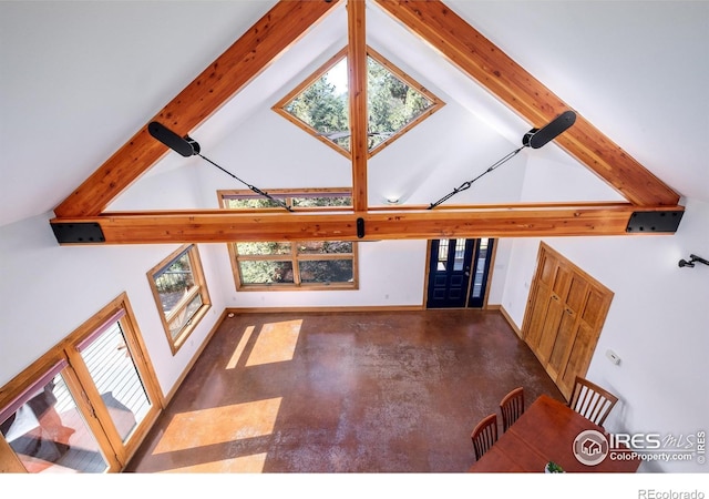 unfurnished living room featuring beamed ceiling and high vaulted ceiling