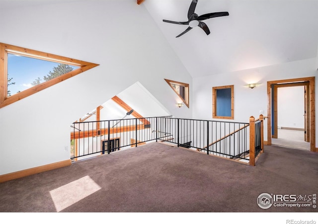 bonus room with dark carpet, high vaulted ceiling, and ceiling fan