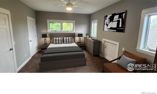 carpeted bedroom featuring multiple windows and ceiling fan