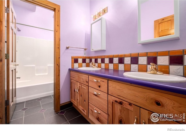 bathroom featuring tasteful backsplash, tile patterned flooring, vanity, and shower / bath combination