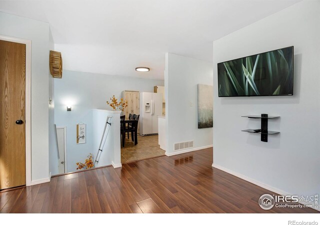 corridor featuring dark hardwood / wood-style flooring