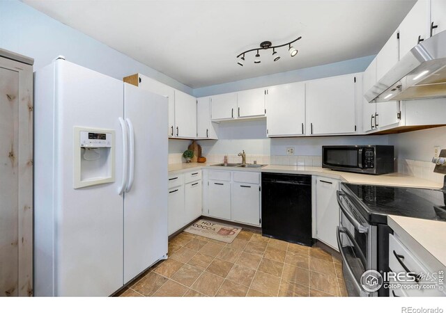 kitchen with stainless steel appliances, white cabinetry, and sink