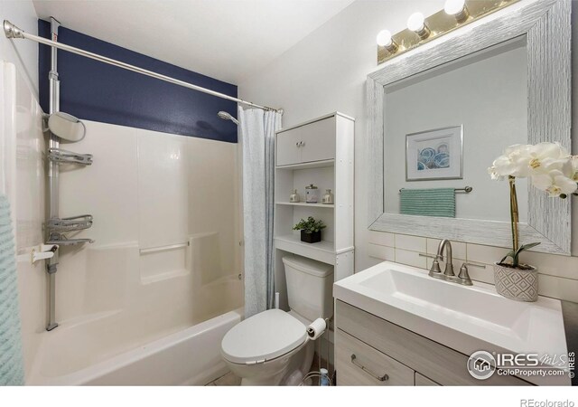 full bathroom with decorative backsplash, vanity, shower / bath combination with curtain, and toilet