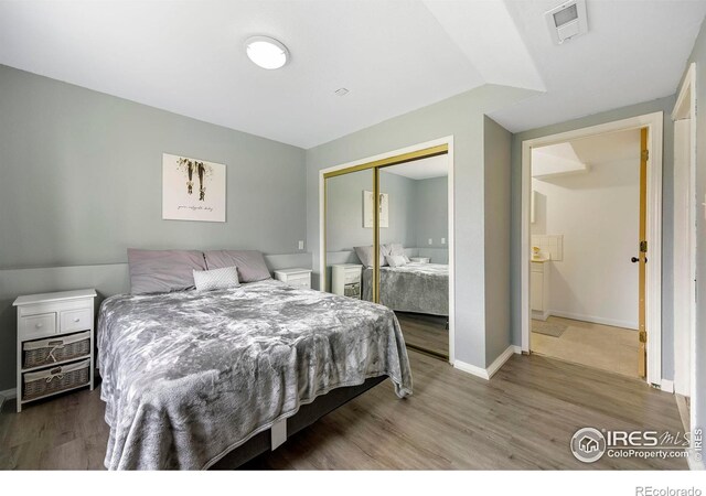 bedroom with hardwood / wood-style floors and a closet