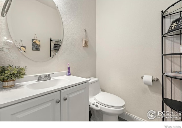 bathroom featuring vanity and toilet