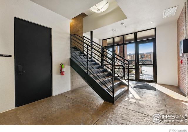 staircase with a wall of windows