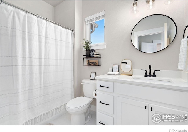 bathroom with tile patterned flooring, vanity, and toilet