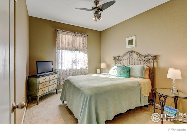 bedroom with light carpet and ceiling fan