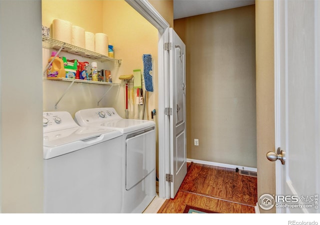 laundry area featuring separate washer and dryer and dark hardwood / wood-style floors