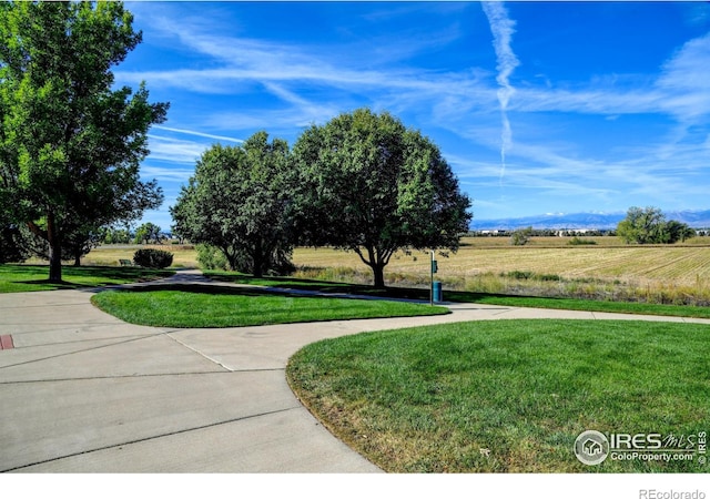 view of community featuring a yard and a rural view